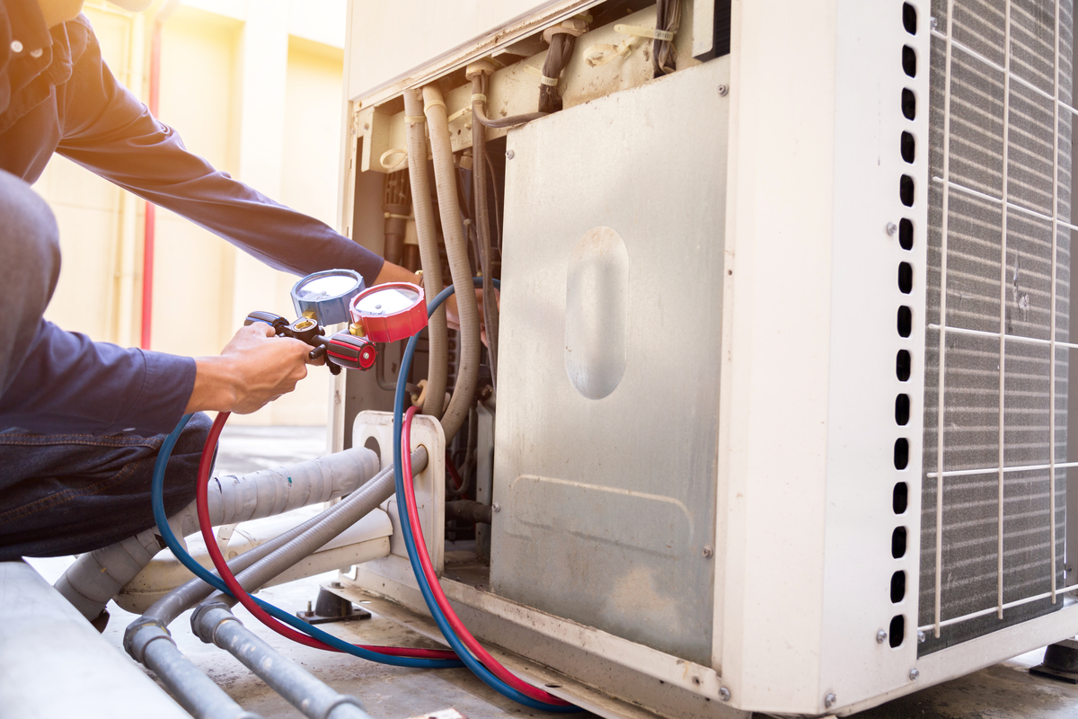 HVAC Tech repairing outdoor ac unit