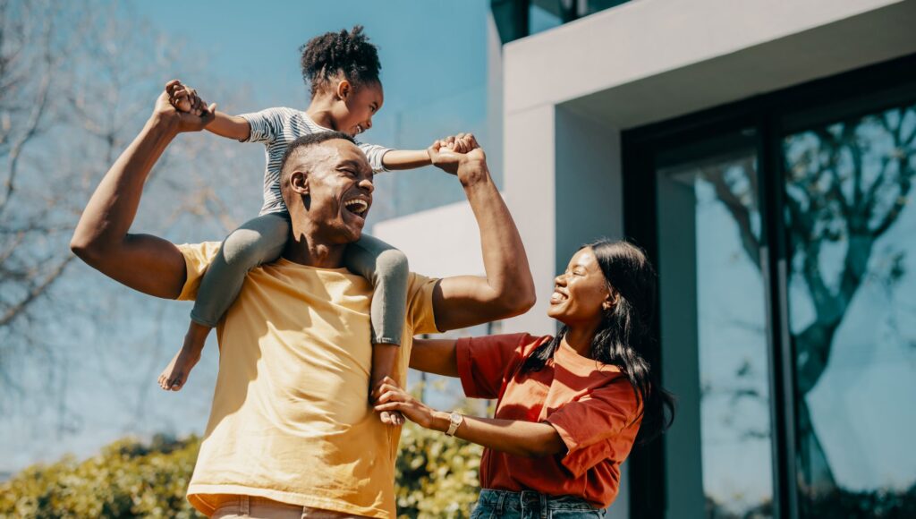 Happy family outside of home