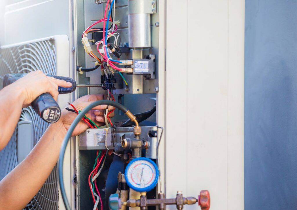 HVAC technician repairing an air conditioning unit